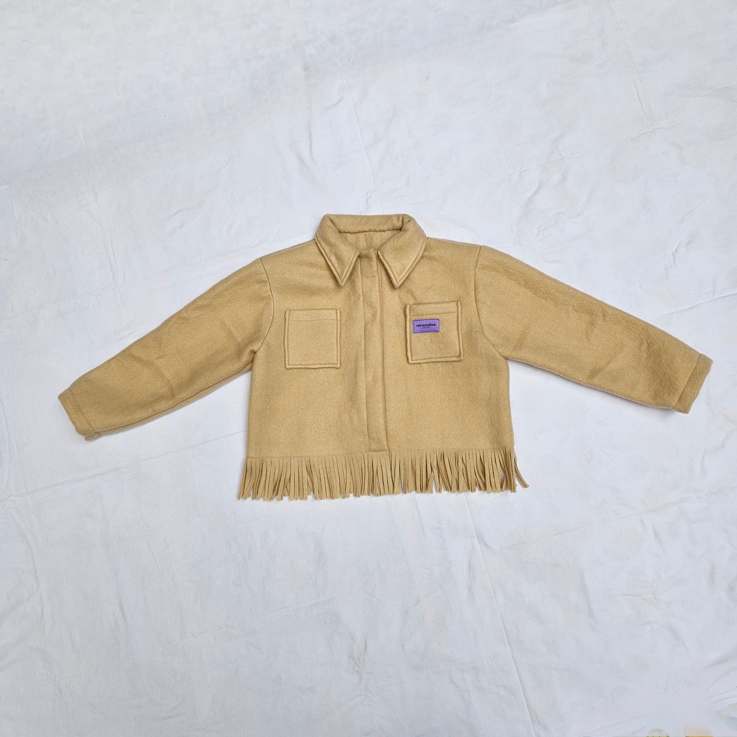 Veste couverture à franges